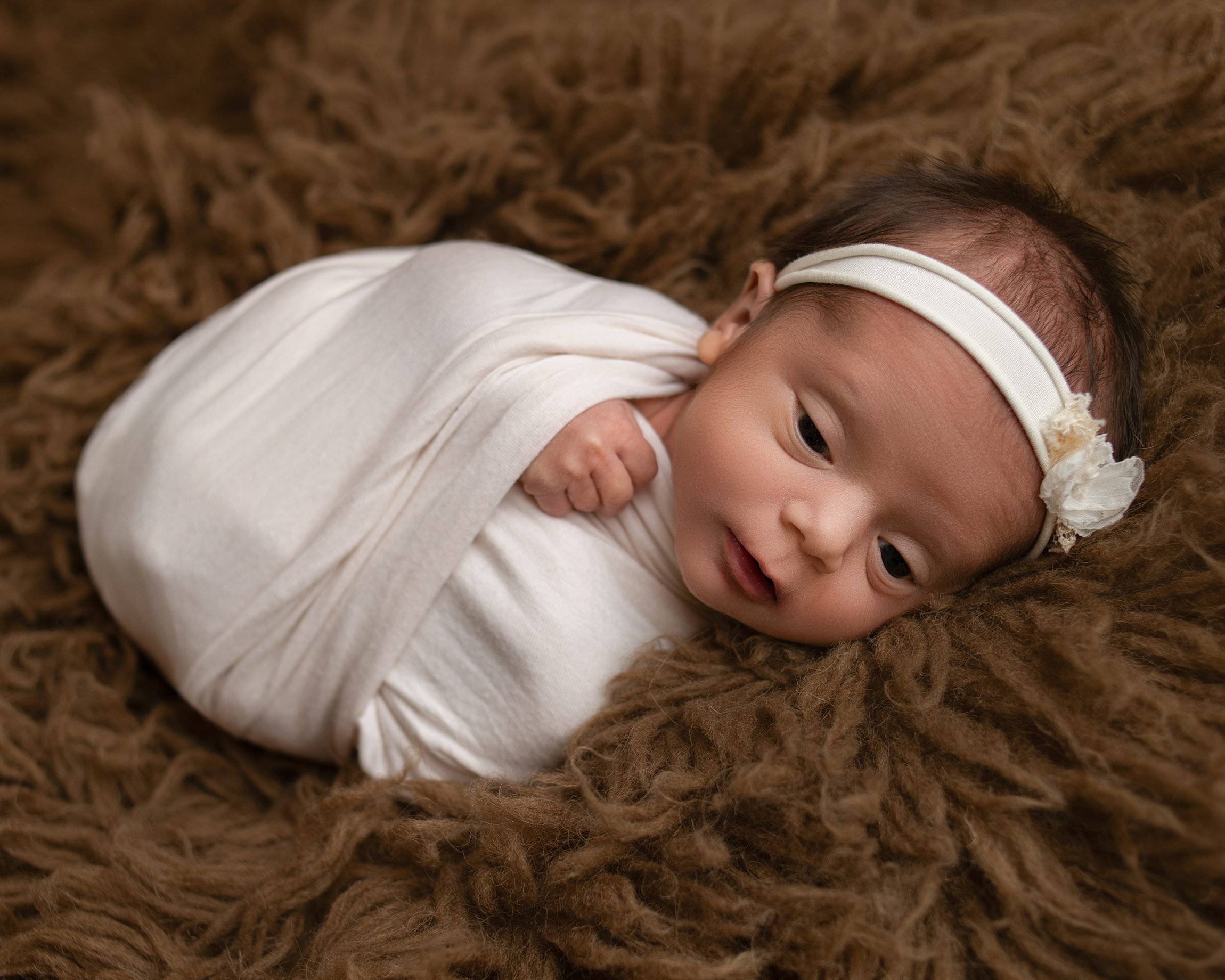 Newborn baby girl portrait created by a San Marcos newborn photographer
